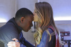 David Harewood being kissed on the head by Melissa Benoist in Supergirl