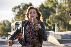 Isla Fisher running down the street with shoes in hand in Wolf Like Me - Season 1