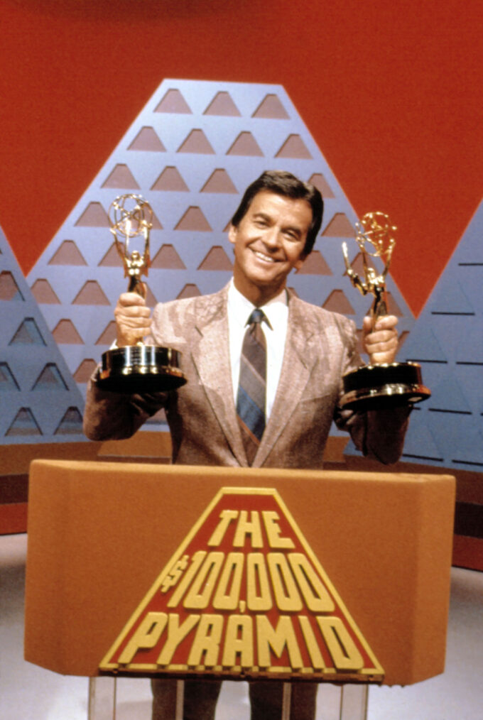 Dick Clark holding Emmys for the $100,000 Pyramid