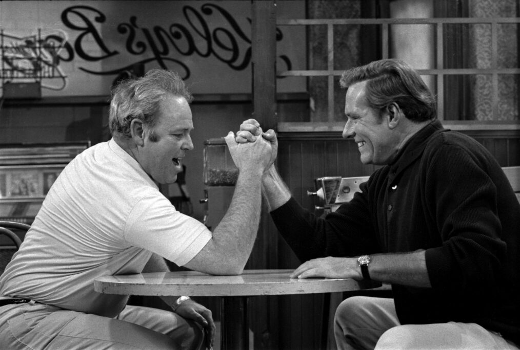 Carroll O'Connor as Archie Bunker arm wrestling Philip Carey as Steve, an ex-professional football player friend of Archie's, in 'All In the Family'