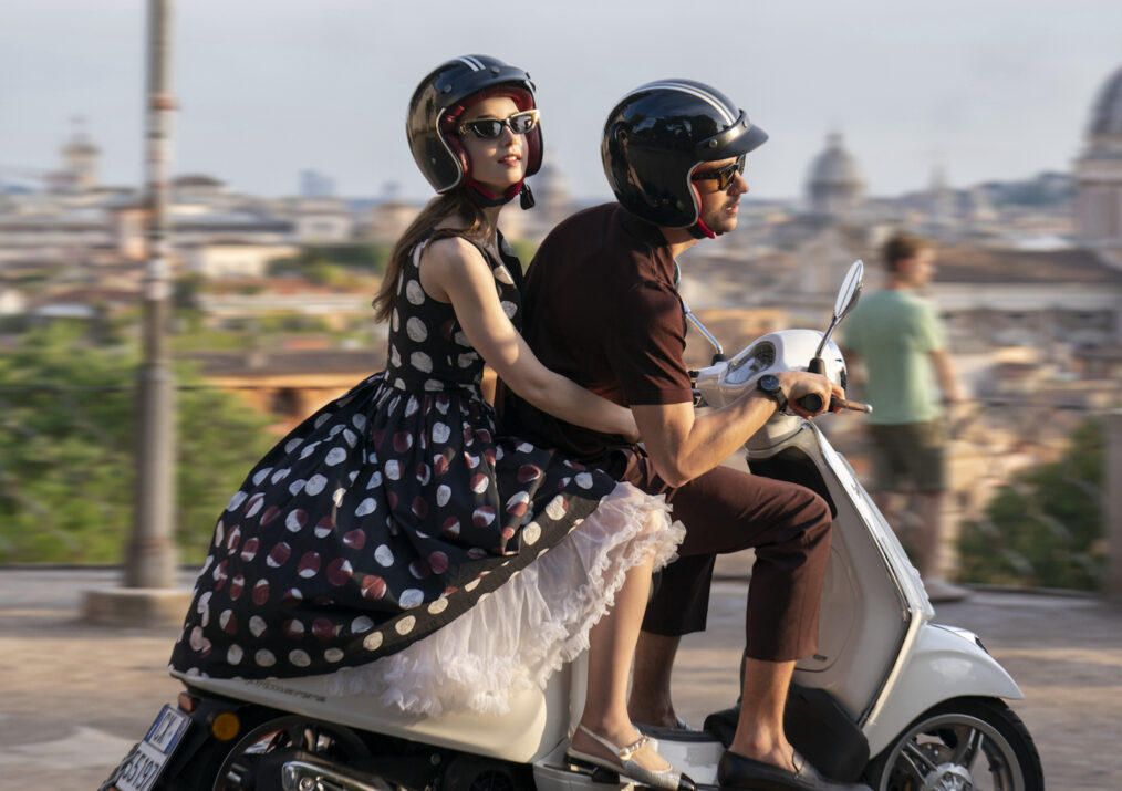 Lily Collins as Emily, Eugenio Franceschini as Marcello on a Vespa in 'Emily in Paris' Season 4