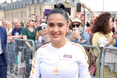 Salma Hayek runs during the Paris Olympics torch relay on July 23, 2024 in Versailles, France. Paris will host the Summer Olympics from July 26 to August 11, 2024.