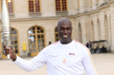 Steve Toussaint carries the flame during the Paris Olympics torch relay on July 23, 2024 in Versailles, France. Paris will host the Summer Olympics from July 26 to August 11, 2024.