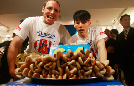 Former champion Takeru Kobayashi and reigning champion Joey Chestnut look on at the Nathan's Famous Fourth of July International Hot Dog Eating Contest official weigh-in ceremony July 2, 2009 in New York City. Chestnut defeated arch rival Kobayashi of Japan in an overtime battle last year by consuming 64 hot dog