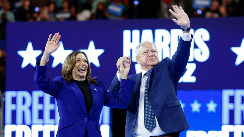 TOPSHOT - US Vice President and 2024 Democratic presidential candidate Kamala Harris and her running mate Minnesota Governor Tim Walz wave to the crowd after speaking at the campaign rally at the Fiserv Forum in Milwaukee, Wisconsin, August 20, 2024. (Photo by KAMIL KRZACZYNSKI / AFP) (Photo by KAMIL KRZACZYNSKI/AFP via Getty Images)