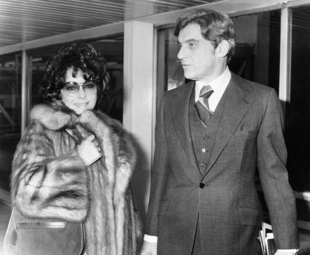 Actress Elizabeth Taylor with her seventh husband, John Warner, arriving at Heathrow Airport for a family christmas in London.