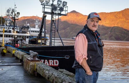 Captain of the Wizard Keith Colburn posing on dock in front of the Wizard