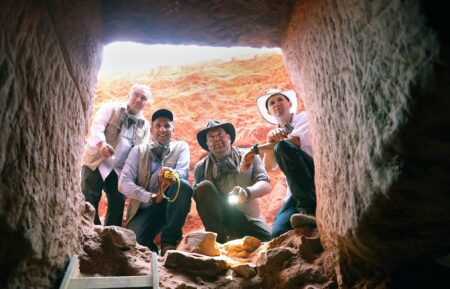 Explorer Josh Gates and Professor Pearce Paul Creasman, joined by Dr. Fares Braizat, ChiefCommissioner of the Petra Development and Tourism Region Authority and Professor FadiBalawi, Director General of the Department of Antiquities of Jordan, peering into the newlydiscovered tomb at Petra