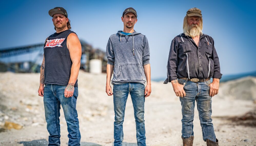 Tony Beets, Parker Schnabel, Rick Ness posing together, conveyor in background