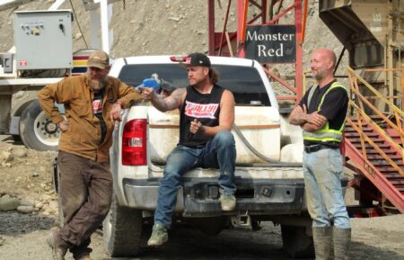 Rick Ness, Buzz Legault and Jason Folster by truck infront of Monster Red