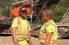 Tyson Lee and Mike Tupper in conversation, washplant on lowboy in background in Gold Rush