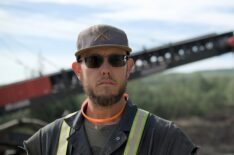 Kevin Beets stood with wash plant in background, looking down lens in Gold Rush