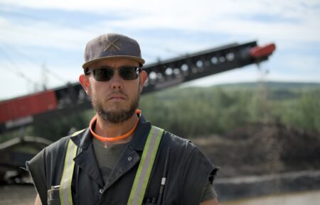 Kevin Beets stood with wash plant in background, looking down lens in Gold Rush