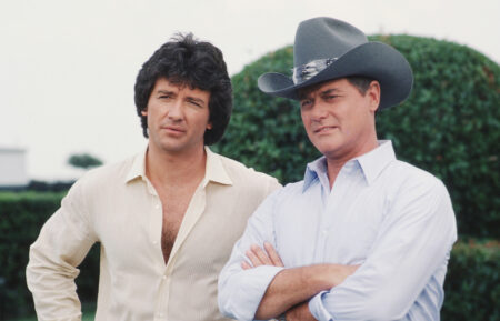 American actors Patrick Duffy (left) and Larry Hagman, as Bobby Ewing and John Ross 'J.R.' Ewing Jr., stand together in a promotional still from the American television series 'Dallas,' August 1982.